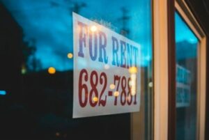 A property for rent sign and number.